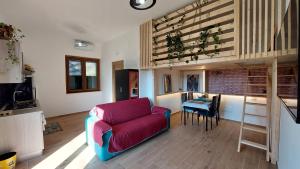 a living room with a couch and a table at Rosa Room in Castelnuovo Cilento