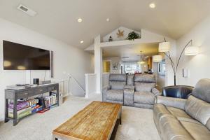 a living room with a couch and a table at A Place away from the Pace in Rockaway Beach