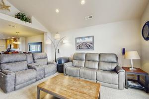 a living room with two couches and a table at A Place away from the Pace in Rockaway Beach