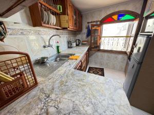 a kitchen with a sink and a counter top at Dar Yema in Asilah