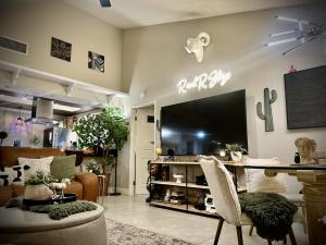 a living room with a large flat screen tv at Spacious 1 BR villa on golf course with epic views! in Palm Desert