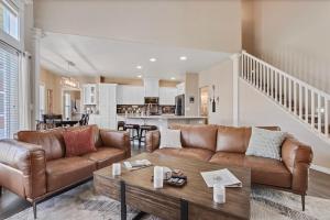 a living room with a couch and a table at Eagles Landing Spacious Family Getaway w Office in Eagle
