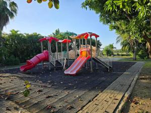 a row of slides in a playground at Hibiscus Retreat in Banks