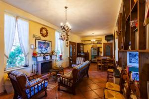 a living room with chairs and a fireplace at Fattoria Terra e Libertà in Contrada Maeggio