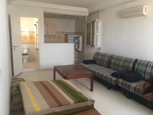 a living room with a couch and a table at Villa Alia Kerkennah in Sidi el Moujahed