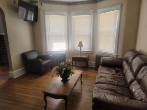 a living room with a couch and a table at CareHouse Residence in Lawnside