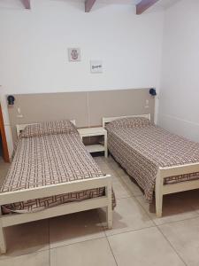 two beds sitting next to each other in a room at TRINIDAD in San Juan