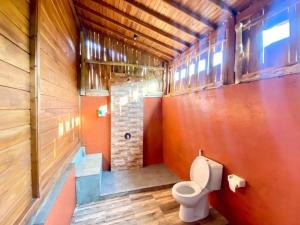 a bathroom with a toilet in a wooden building at Uluwatu Wooden Villa in Uluwatu +41 photos