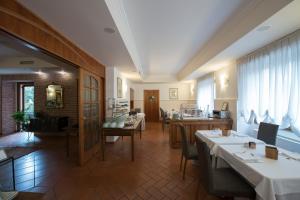 a restaurant with two tables and a dining room at Hotel Villa Colico in Colico