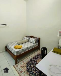 een kleine kamer met een bed en een tafel en een tafel en een tafel bij Azo Homestay Parit Raja in Parit Raja