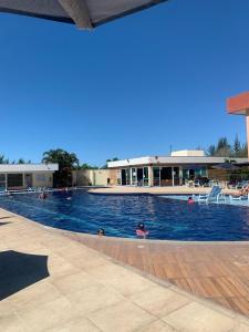 a group of people swimming in a swimming pool at Alojamiento Arraial Do Cabo Golden Lake in Arraial do Cabo