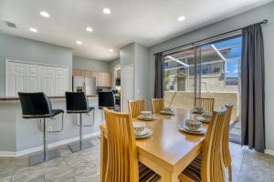 Una cocina y un comedor con mesa y sillas. en Stylish Townhome Close to Disney Parks, en Kissimmee