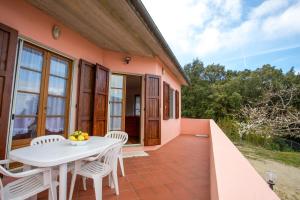 a table and chairs on the balcony of a house at Villino Mare e Natura in Marciana Marina