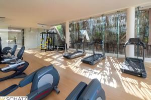 a gym with treadmills and elliptical machines at Residencial Ophelia Tulum in Tulum