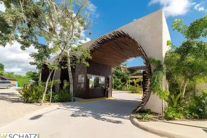 a rendering of a house with an archway at Residencial Ophelia Tulum in Tulum