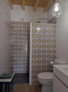 a bathroom with a toilet and a shower at Armazéns do Beco - Cacau, Pimenta e Sal in Santa Cruz da Graciosa +37 photos