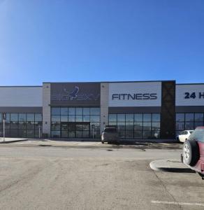 a car parked in a parking lot in front of a store at Brand-New Guesthouse-2bedrooms in Calgary