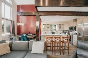 a living room with a couch and a kitchen at 80MBR - Hot Tub - WIFI - BBQ - Wood Stove - Sleeps 7 in Deming