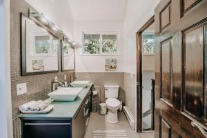 a bathroom with a sink and a toilet at 80MBR - Hot Tub - WIFI - BBQ - Wood Stove - Sleeps 7 in Deming +23 photos