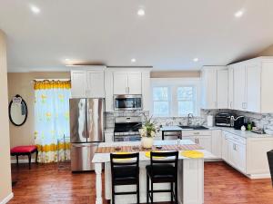 a kitchen with white cabinets and a table with chairs at Delightful dwelling in Buffalo