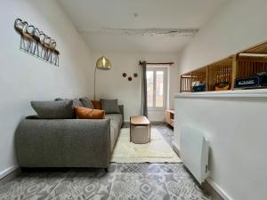 a living room with a couch and a table at La bâtisse de Coustouge in Coustouge