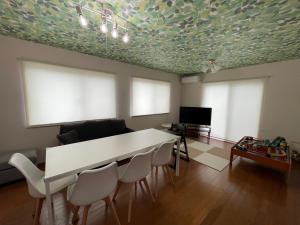 a living room with a white table and chairs at Japan Family & Kids Castle Hotel Tokyo in Kisarazu
