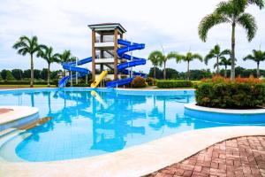 a water slide in a pool at a resort at Sotogrande Iloilo Hotel in Iloilo City