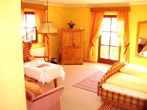 a living room with a couch and a table at Eichenhof in Waging am See
