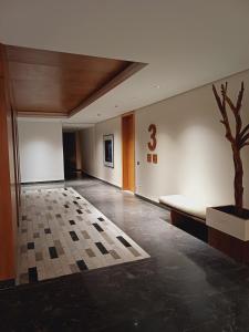 a room with a couch and a tree on the wall at Panoramic ocean view appartement in Casablanca +22 photos