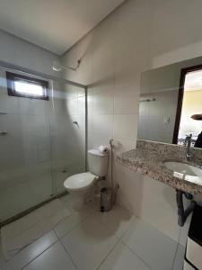 a bathroom with a toilet and a shower and a sink at Casa em Lençóis in Lençóis +18 photos