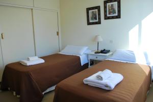 En eller flere senge i et værelse på Hotel Gran Madryn