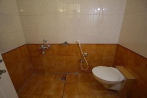 a bathroom with a toilet and a shower at villas holiday family home service in Surat +11 photos