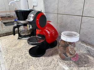 a red mixer sitting on a counter next to a jar at Cantinho da Cerejeira in Santo Antônio do Pinhal +32 photos