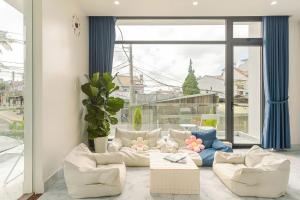 a living room with couches and a large window at Ami Villa Dalat in Da Lat +88 photos