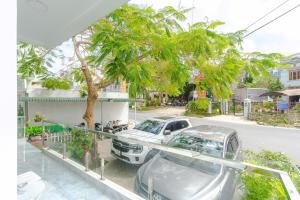 a white car parked on the side of a street at Ami Villa Dalat in Da Lat