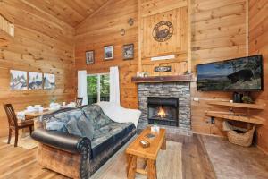 a living room with a couch and a fireplace at 3mil to Dwnt Gtbg 3Beds 2 Bath HotTub Fireplace Arcade Fire Pit in Gatlinburg