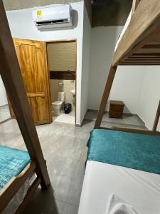a room with a bunk bed and a bathroom at BYMAR Resort in Necoclí +21 photos