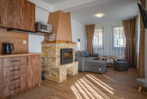 a living room with a couch and a fireplace at Spa Villas Daffi in Smolyan