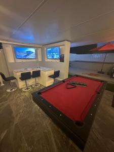 a room with a pool table in the middle of a room at Luxury Entertainment home Hard rock stadium in Opa-locka