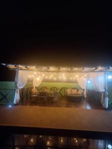 a stage with a couch and a living room at Sitio trem bao demais in Mateus Leme