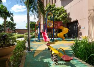 a playground with a slide in a garden at Berjaya Times Square Hotel, Kuala Lumpur in Kuala Lumpur