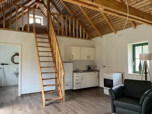 a living room with a spiral staircase in a loft at Ferienhaus nahe Schweriner Seenplatte in Wendorf