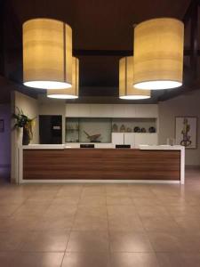 a large room with two lights and a counter at Malawi Resort Experience INN in Porto De Galinhas
