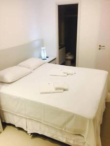 a large white bed in a white room at Malawi Resort Experience INN in Porto De Galinhas +13 photos