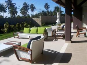 a group of chairs and tables on a patio at Malawi Resort Experience INN in Porto De Galinhas