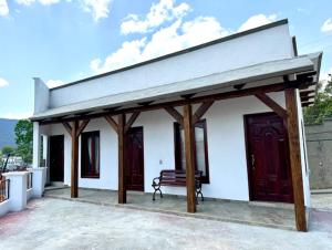 un pabellón con un banco frente a un edificio blanco en Hotel Carretas 2, en Jalpan