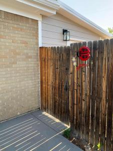 a fence with a ladybug on it next to a house at Charming Two Bedroom Family Unit in Great Location in Denver +17 photos