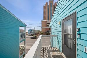 a blue building with a door on a balcony at Vitamin Sea in Gulf Shores