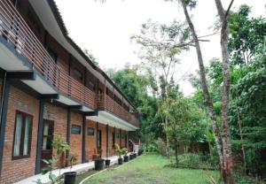 a brick building with balconies on the side of it at KK by Secoms in Yogyakarta