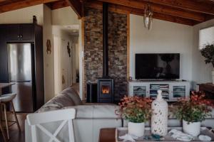 a living room with a couch and a fireplace at Sea Breeze Freycinet - Hot Tub in Coles Bay
